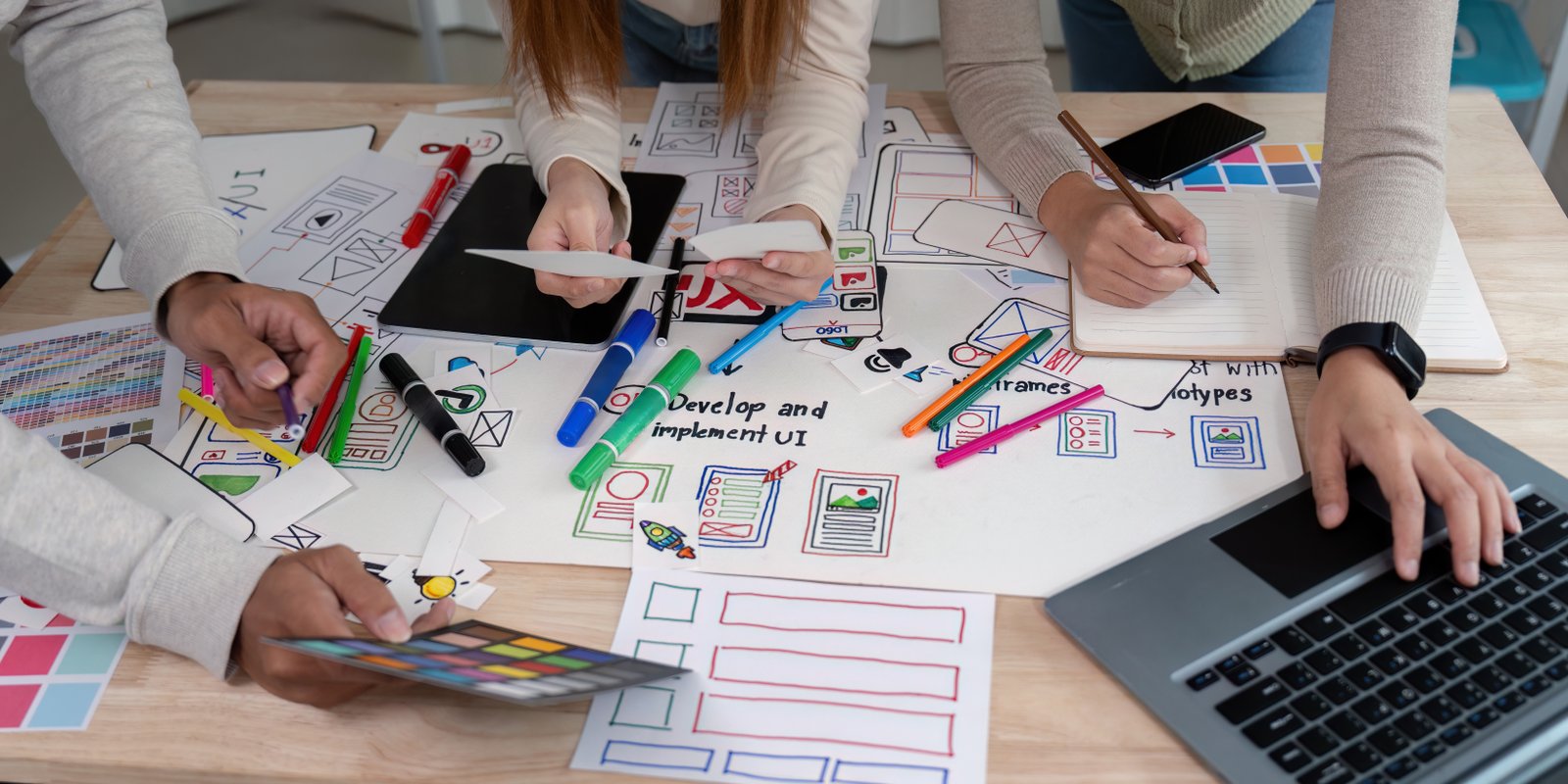 Product design team collaborating on wireframes and prototypes